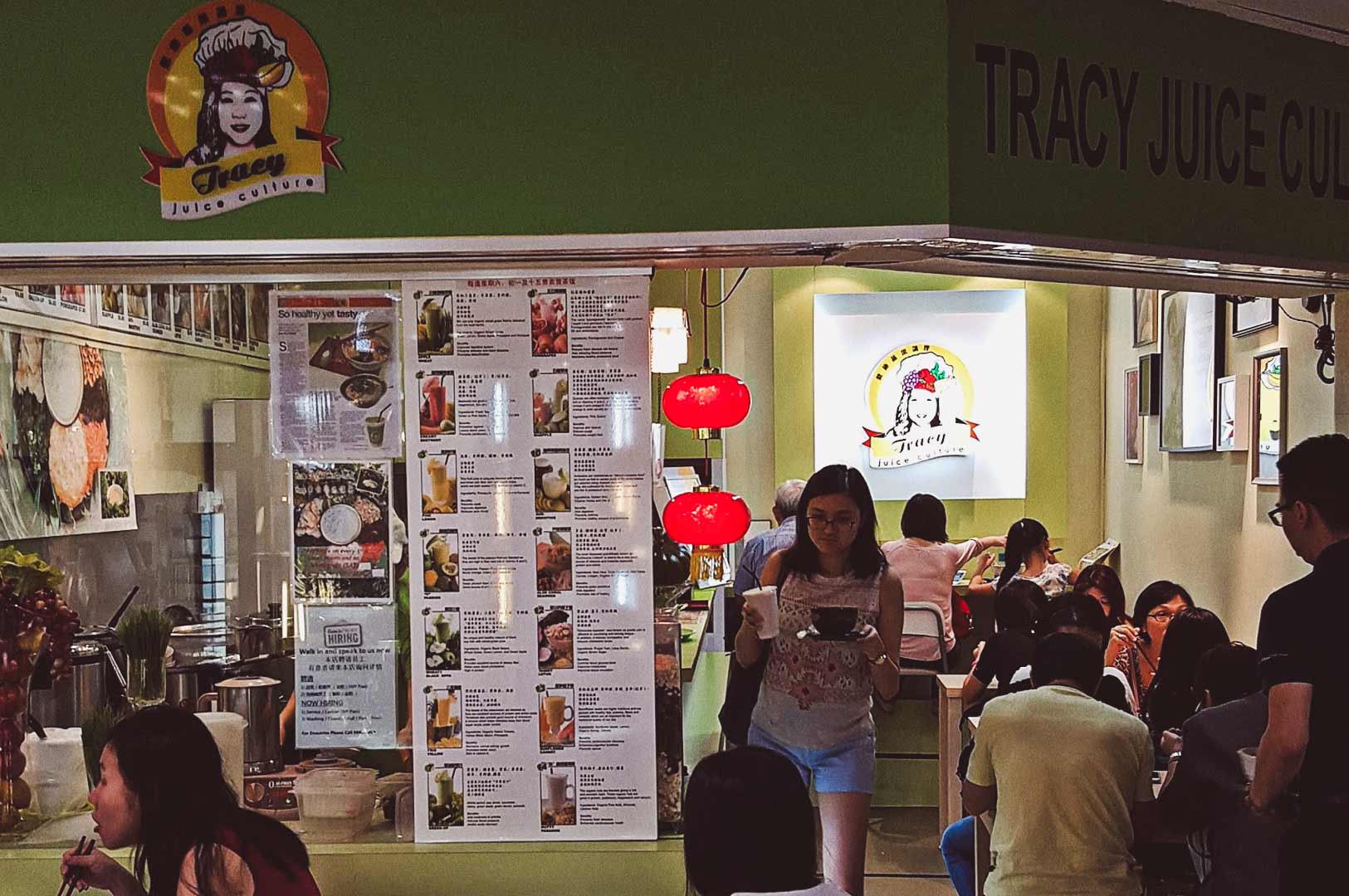 Tracy Juice Culture juice bar, green-themed decor, fruit logo, menu board with Chinese and English items.