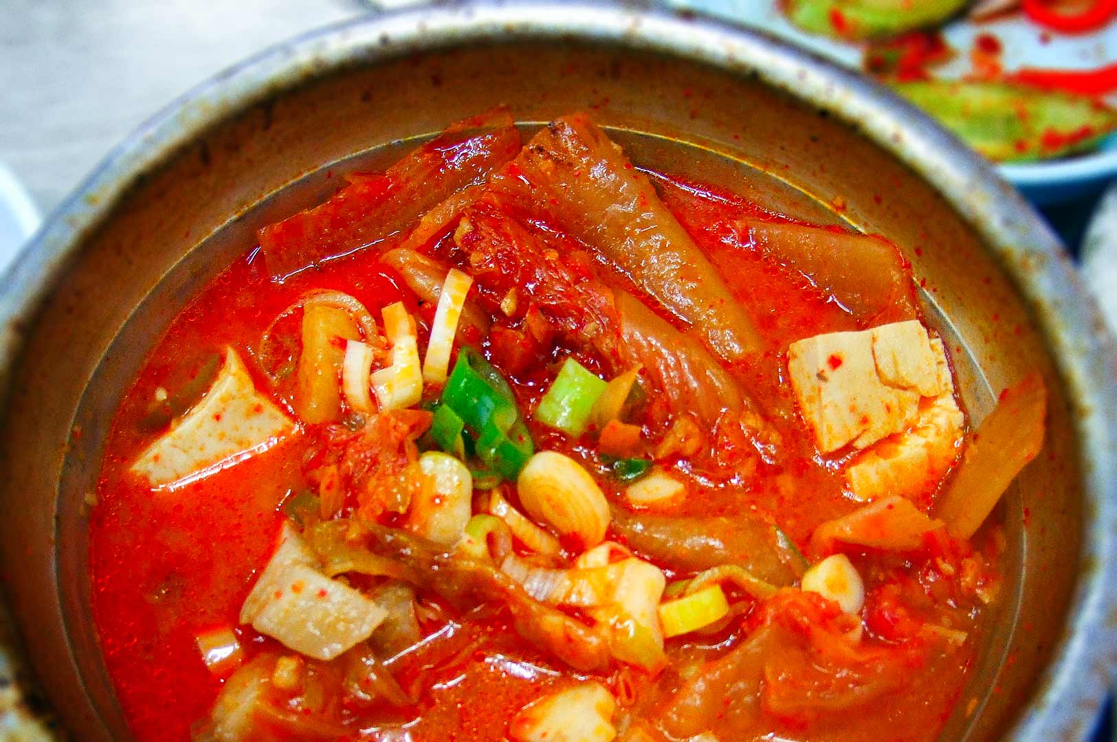 Spicy Korean kimchi jjigae stew with tofu and vegetables.