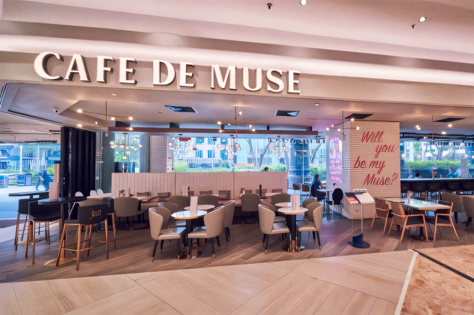 Café de Muse modern interior with warm lighting and large windows.