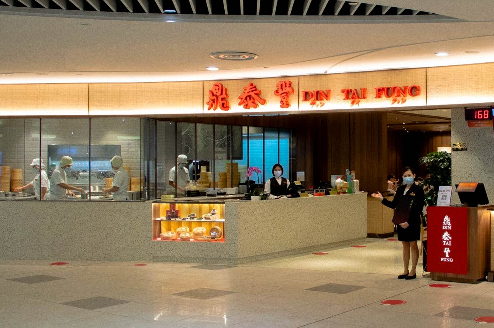 Front counter and open kitchen view at a dumpling restaurant.