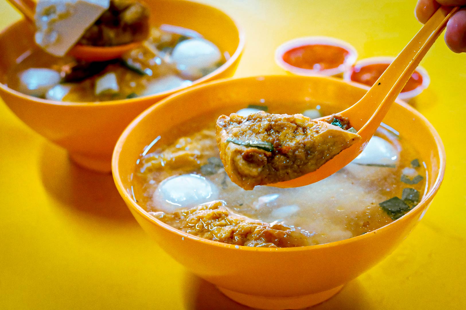Bowls of yong tau foo soup with stuffed tofu and fish balls.