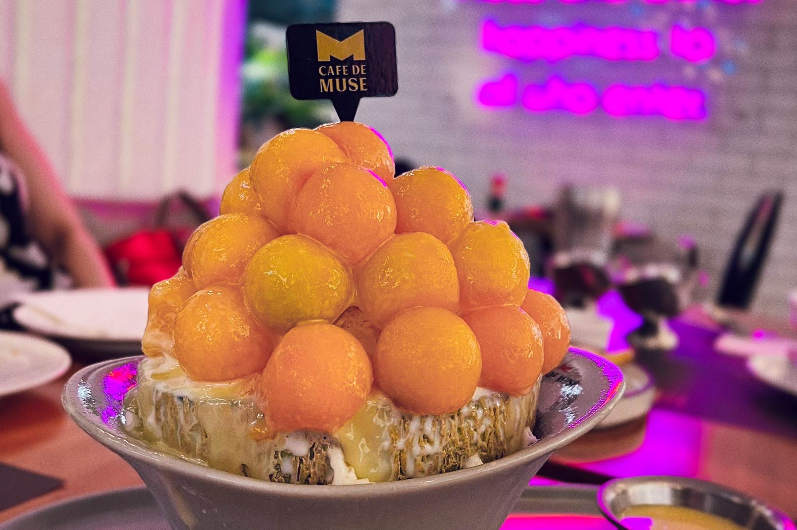 Bingsu with melon balls and creamy drizzle.