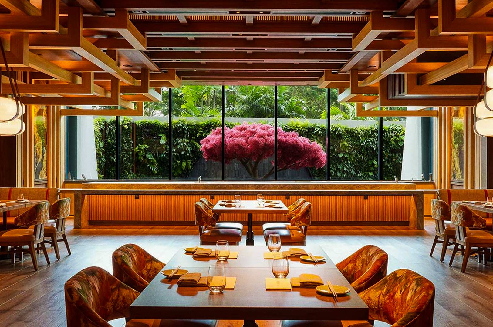 Upscale dining room with large window overlooking lush garden.