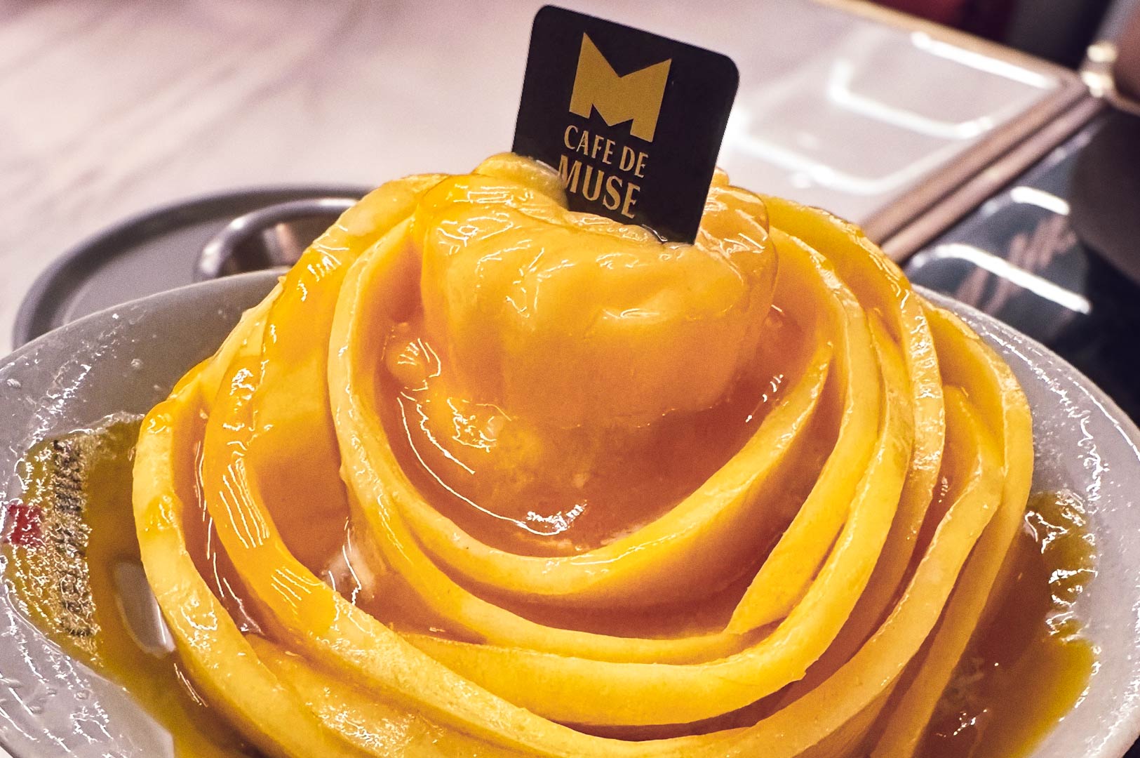 Glazed mango rose bowl with syrup drizzle.