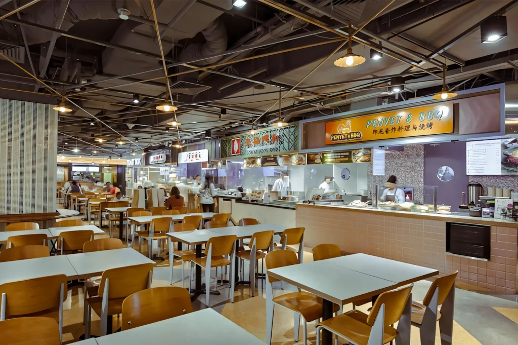 1 How We Found the Best Mall for Foodies Wide-angle eye-level view of a modern food court with multiple food stalls, open seating, and bright overhead lighting, offering diverse dining choices ideal for picky eaters and groups.