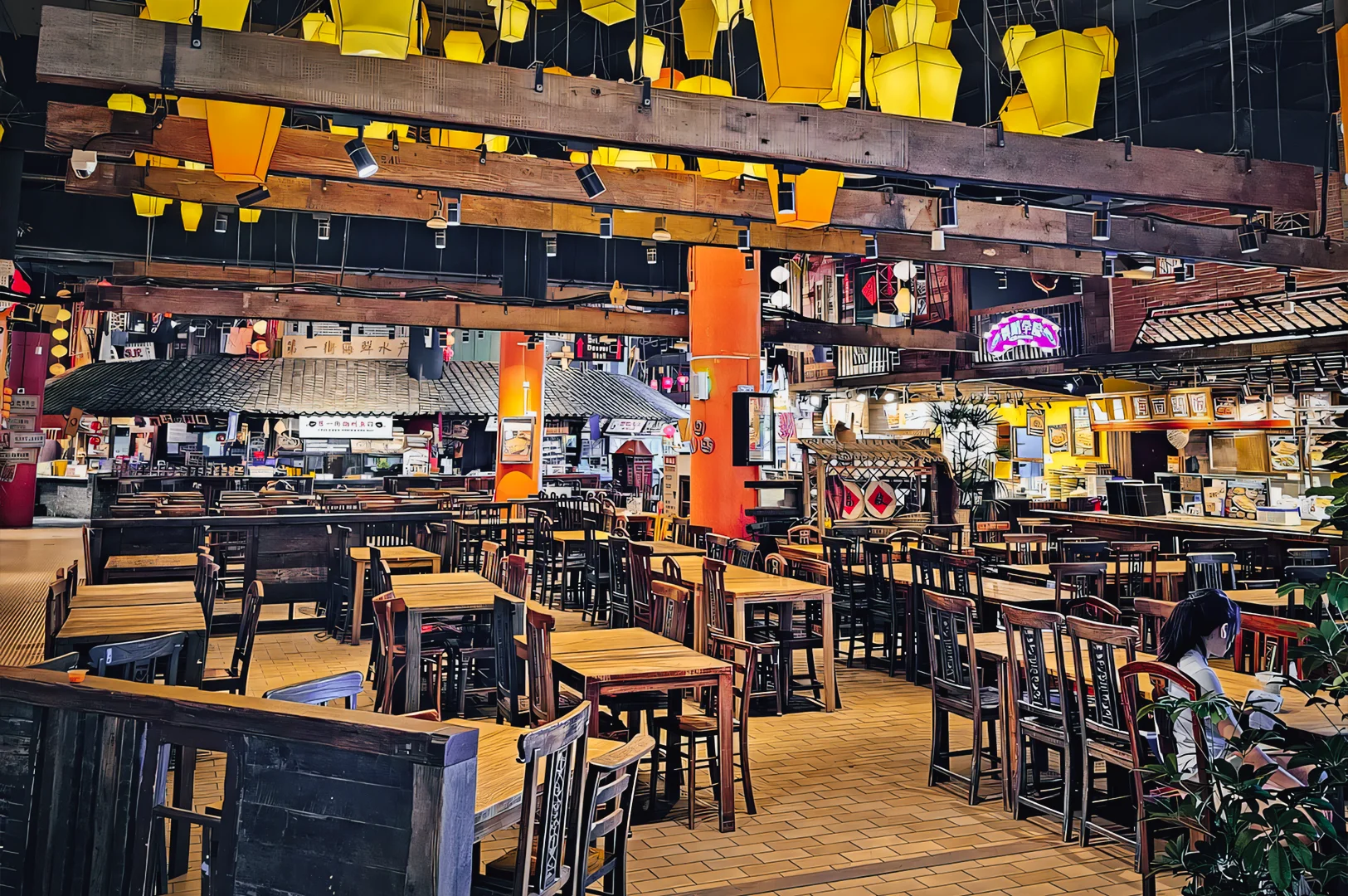 Wide-angle eye-level shot of an Asian-inspired mall food court with empty wooden tables and chairs, yellow lanterns overhead, and illuminated food stalls in the background, showcasing a spacious indoor dining environment.