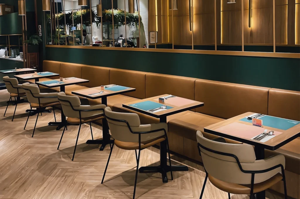 Wide-angle diagonal view of The Marmalade Pantry interior at ION Orchard, showing modern cushioned seating, wood accents, and relaxed open-concept dining ambiance for brunch and lunch