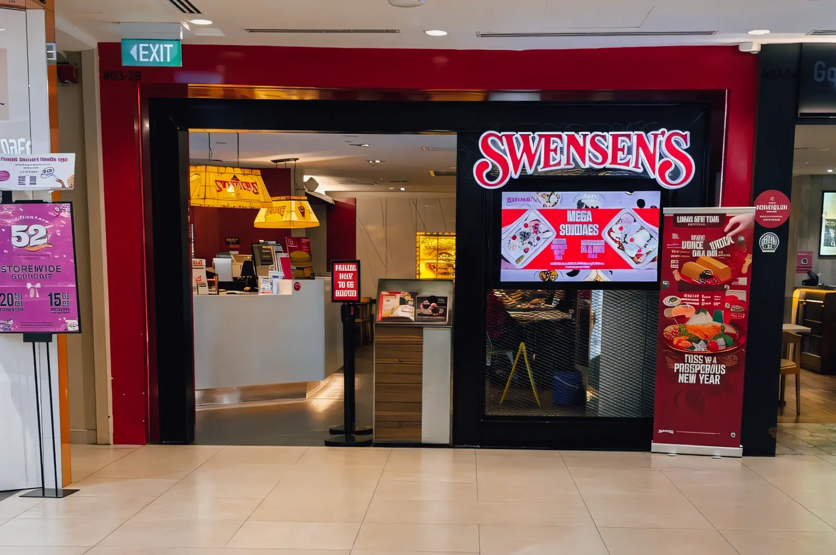 Straight-on frontal shot of Swensen’s entrance at Plaza Singapura, featuring illuminated signage and dessert promotions in a family-friendly Orchard Road dining location.