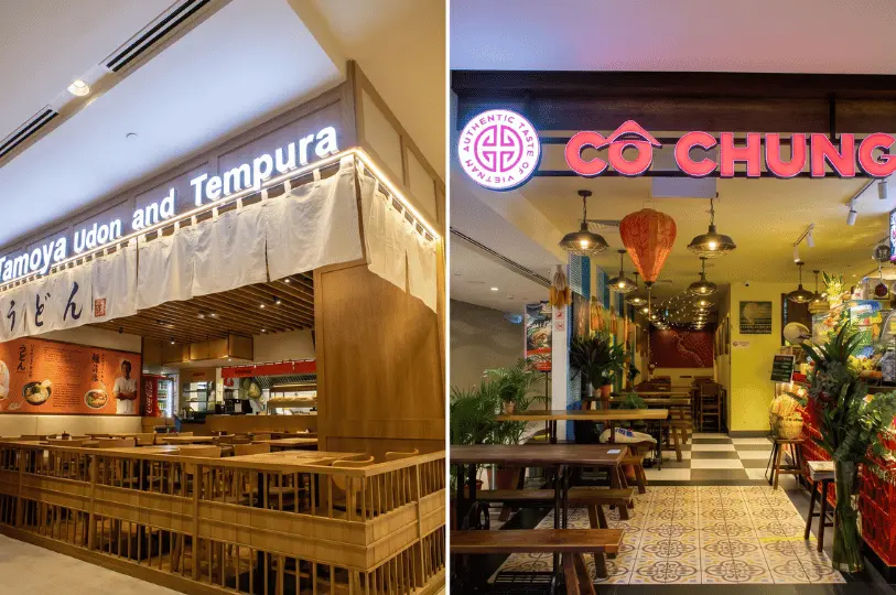 Side-by-side view of two casual dining storefronts inside a mall: a Japanese Tamoya Udon and Tempura restaurant with wooden accents on the left, and a vibrant Cô Nhung Vietnamese restaurant with red signage and traditional lanterns on the right.