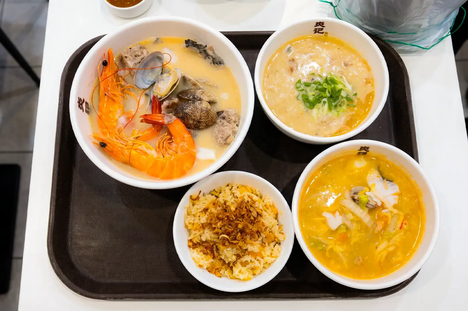 Flat lay shot of seafood bowl menu items served on a tray at Yan Ji Gourmet Seafood Soup.