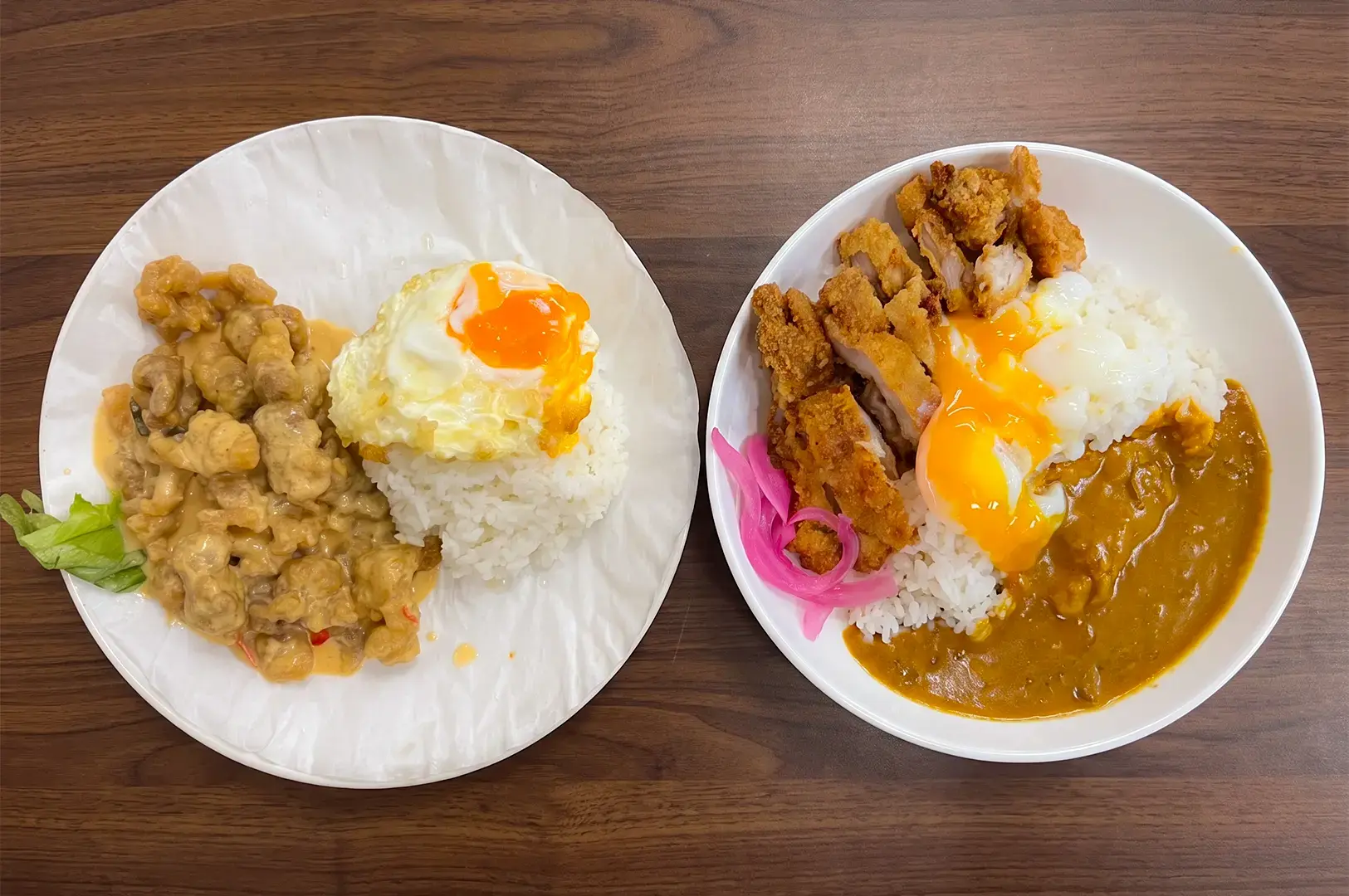 Flat lay view of New Station Rice Bar menu items including the Salted Egg Pork Rice beside another dish plate.